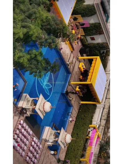 My coverage includes all your wedding events. A top-down drone view of a Haldi ceremony captures the vibrant yellow decor and the beautiful poolside setup in a single, comprehensive frame.
