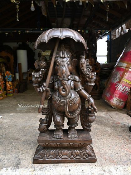 The brown finish version of the 36-inch Umbrella Ganapathy, showing the warm tones of the wood.