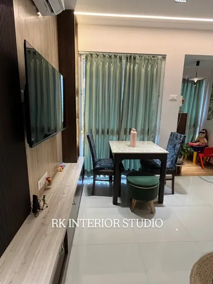 A closer look at the TV unit and compact dining setup. The fluted panel on the TV wall adds texture, while the sleek dining table is perfect for a small family.