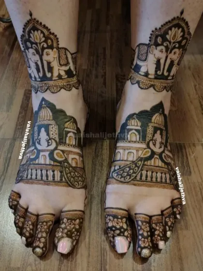 A bride's look is complete with beautiful mehndi on her feet. I designed this piece with royal palace architecture, majestic elephants, and peacocks to create a truly grand statement.