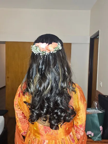 Soft waves and a half-up twist, adorned with fresh flowers. This hairstyle was created for Monica's baby shower.