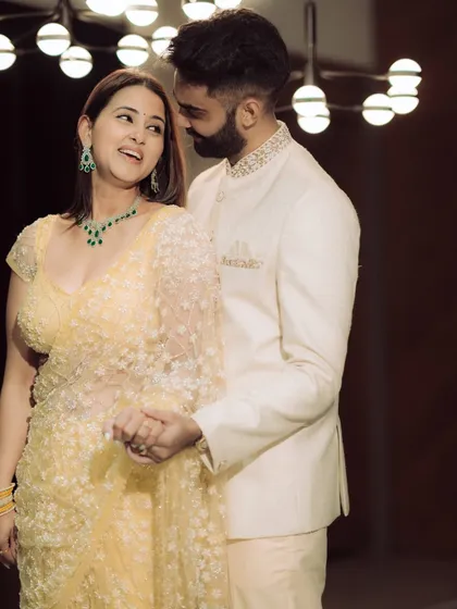 A moment of pure, unscripted laughter. The groom whispers something to his bride-to-be, and her resulting joy is beautifully captured, showcasing the genuine connection that makes for the best photographs.