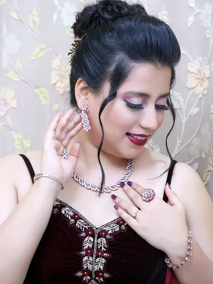 My client admiring her jewelry, which pairs perfectly with the cool-toned makeup look I created for her.