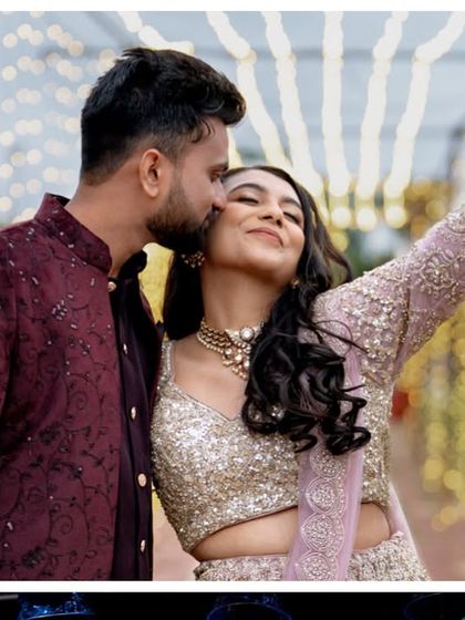 A romantic moment between the couple, captured under the enchanting canopy of fairy lights during their Sangeet event.