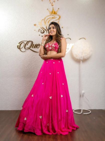 Another shot of the client in the bright pink lehenga, showing her happy smile.