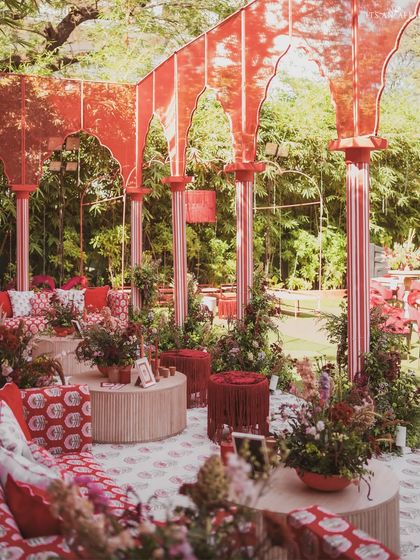 An interior view of one of the seating pavilions, filled with custom textiles, florals, and intricate design elements.