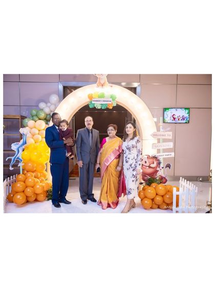 A happy family poses at the entrance of our Lion King themed party. The light-up arch and character props create a magical welcome for guests of all ages.