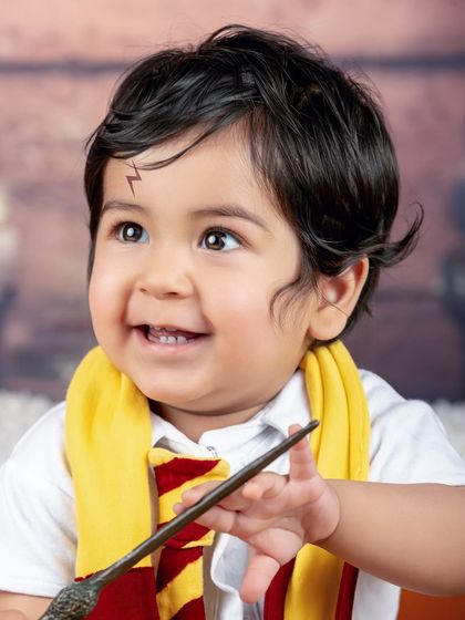 A close-up of our little wizard, looking up with a magical sparkle in his eye. The lightning bolt scar is the perfect finishing touch.