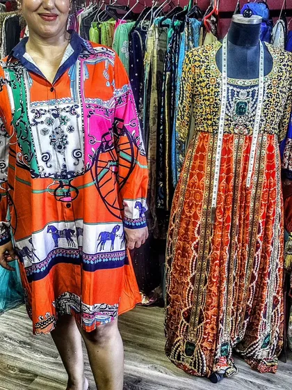I offer customized wardrobes using your fabrics or mine. Here you can see a client in a custom-stitched shirt dress and a mannequin displaying a beautiful Anarkali, showcasing the range of styles I can create.