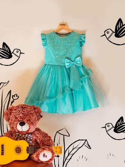 This turquoise dress is a showstopper with its layered tulle skirt and embroidered bodice. It's a design that feels both modern and magical, perfect for a little fashionista.
