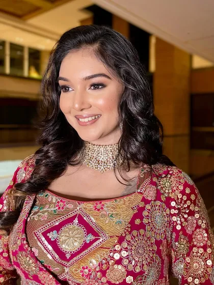 A close-up of the bride's happy expression. The makeup is radiant and camera-ready.