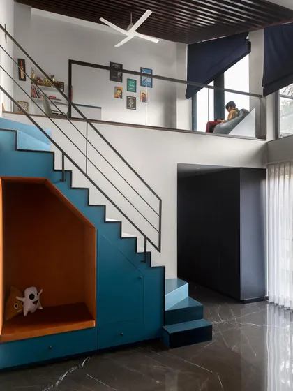 A dream room for a child, this space features a multi-level layout with a cozy reading nook tucked under the stairs and a study area on the mezzanine. It’s a design that is both playful and practical.