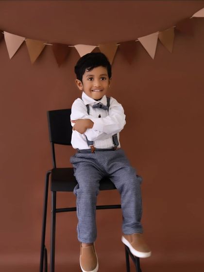 A dapper little gentleman in his bow tie and suspenders. I offer different outfit changes to provide a variety of looks during a birthday session.