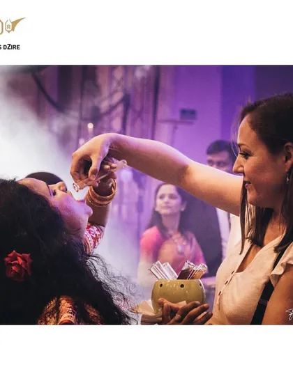 A moment of shared fun as one guest helps another take a shot. Our service is designed to bring people together and create a lively social environment.