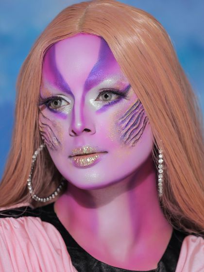 Another angle of the creative face painting look, showing how the makeup interacts with light to create a multi-dimensional effect.