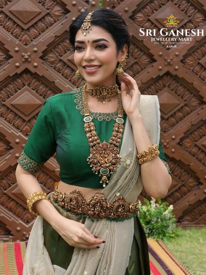 A showcase of traditional elegance for a jewellery brand collaboration. The model's makeup is kept classic and refined to complement the heavy, intricate antique gold temple jewellery, including a stunning haram and oddiyanam.