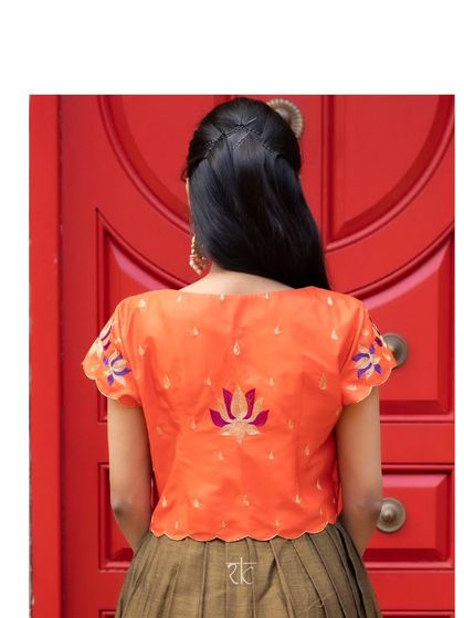 The back of the jacket is adorned with beautiful lotus embroidery, adding a unique and artistic detail.