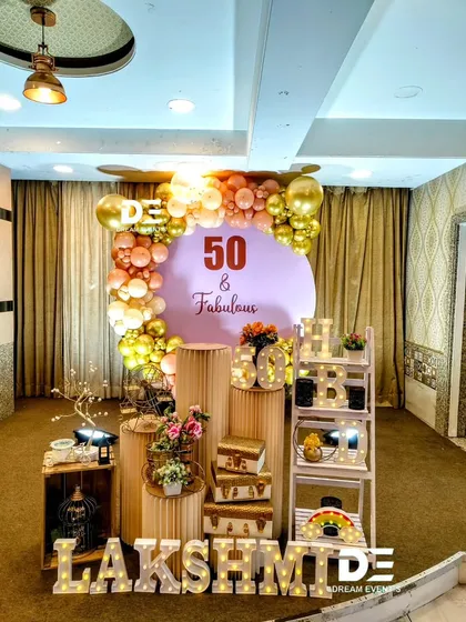 Celebrating a big milestone should be stylish and personal. For this '50 & Fabulous' party, I designed a chic setup with a custom backdrop, an elegant gold and rose-gold balloon arch, and personalized marquee letters to honor the special occasion.