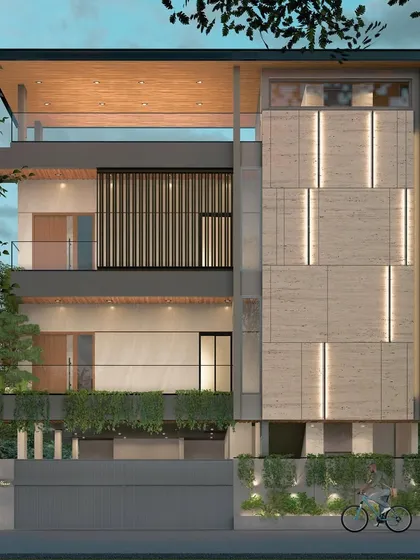 This facade design for a modern residence in Bangalore uses a combination of travertine cladding, vertical gardens, and integrated lighting. The result is a building that feels both innovative and deeply connected to nature.