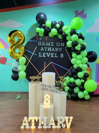Another angle of the 'Game On' setup, showing the foil number balloon and themed cake stands.