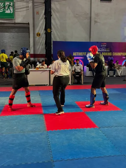 The start of a competitive bout at a local kickboxing championship. Both fighters are focused and ready.