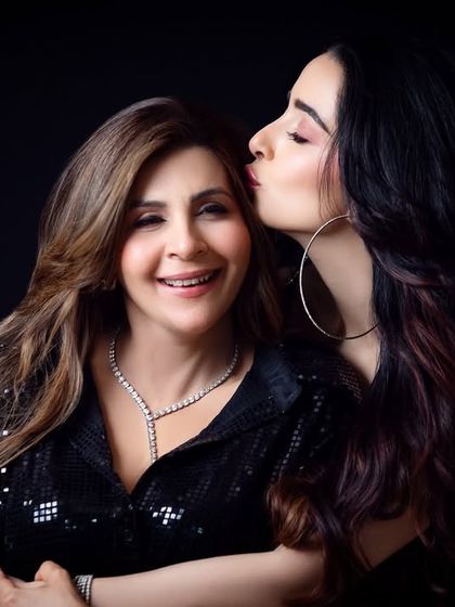 A sweet kiss on the cheek. This photo captures a simple, loving gesture that speaks volumes about the mother-daughter relationship.