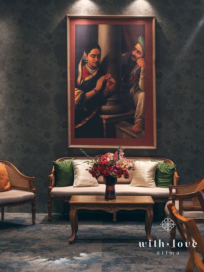 Another view of the intimate seating areas, designed to encourage conversation and connection. The Raja Ravi Varma paintings serve as both decor and conversation starters for the art-loving couple and their guests.