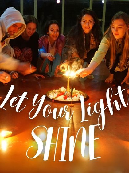 "Let Your Light Shine." Students gather around a candle centerpiece, a beautiful symbol of the inner light, or dharma, that yoga helps us to discover and share with the world.