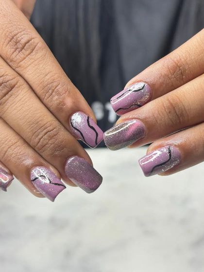 Another angle of the purple and black abstract nail art. This shows that you can have intricate and fun designs on any nail length.