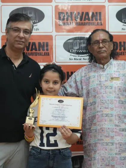 A student with her father and our senior guru at the prize ceremony.
