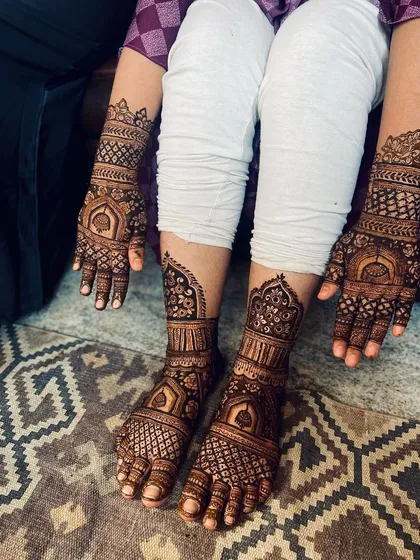 A complete bridal mehendi set, with matching intricate designs for both hands and feet. This shows the full coverage I offer, extending up the forearms and mid-calf, creating a cohesive and stunning look for your wedding day.