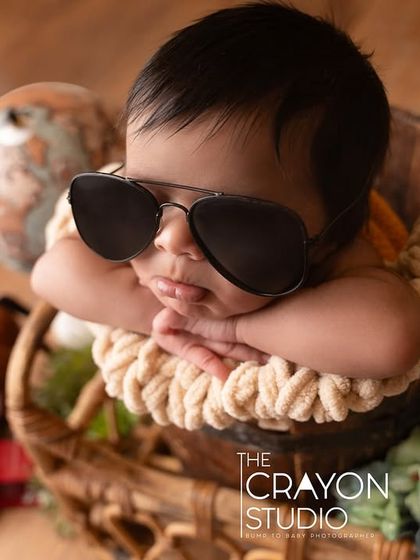 A close-up shot of our tiny traveler, showing the adorable pout and chubby cheeks, even behind the cool shades.