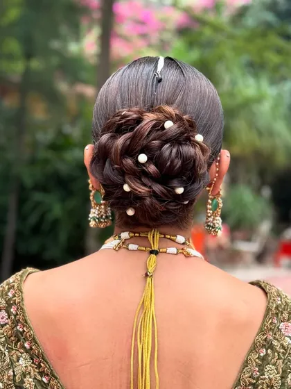 This is my take on the messy bridal updo, where technique meets artistry. I intricately wove the hair into a textured bun and scattered small pearls throughout for a touch of magic. It’s an elegant and modern choice for a bride who wants a sophisticated yet soft wedding hairstyle.