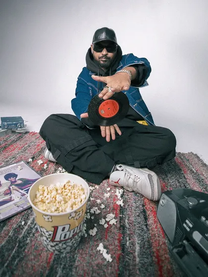 A creative press shot showing my connection to the roots of DJing. Holding a classic vinyl record, this image captures my blend of old-school respect and new-school energy.
