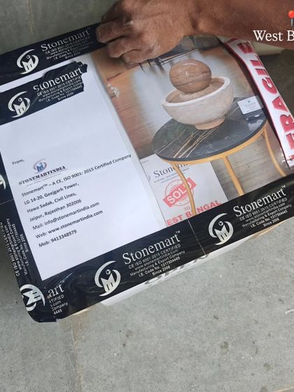 The final packed box for a tabletop fountain, securely taped and labeled for its journey to West Bengal.