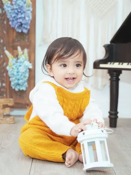 We use a variety of props like this lantern to add interest and give little hands something to hold.