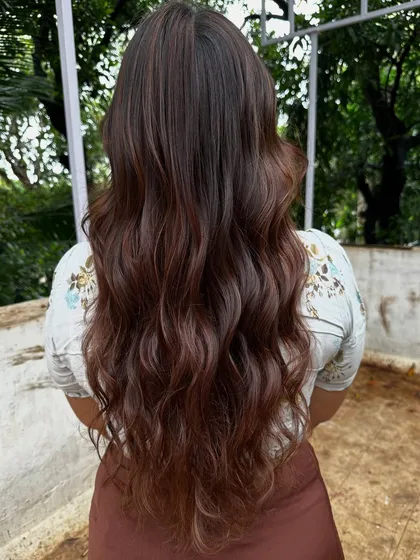 Getting ready for 'Ghar ki shaadi' (a home wedding). This client wanted a glamorous but natural look, so I gave her a rich color melt with soft waves, perfect for the occasion.