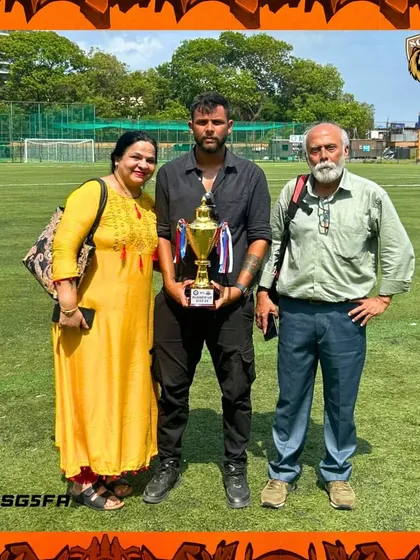 A proud moment for our coach with his parents after a successful tournament. Family support is an integral part of the SG5 journey.