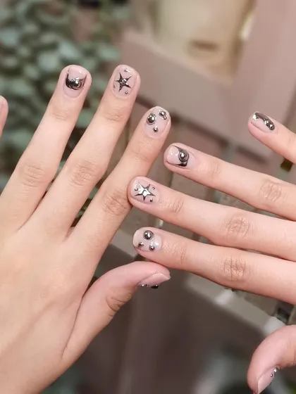 Proof that you don't need long extensions for amazing nail art. This cute celestial design looks fantastic on shorter, natural nails.