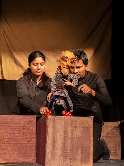 Puppeteers manipulate a small rod puppet of a Lilliputian character, contrasting with the giant scale of Gulliver. The show teaches that it's not your size, but how big you are on the inside that counts.