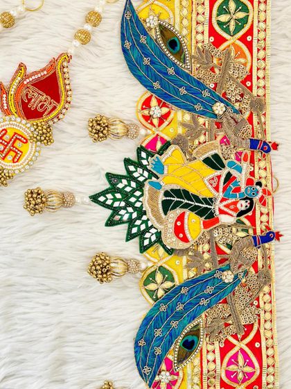 A detailed view of a Radha Krishna bandhanwar. The intricate beadwork and peacock feather motifs are handcrafted with devotion to bring peace and harmony to your home.