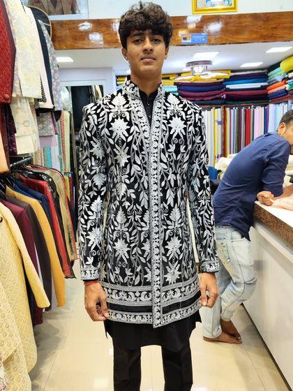 A young client looking confident in his celebrity-inspired black and white embroidered sherwani. I create fashion that matches your personality, no matter your age.