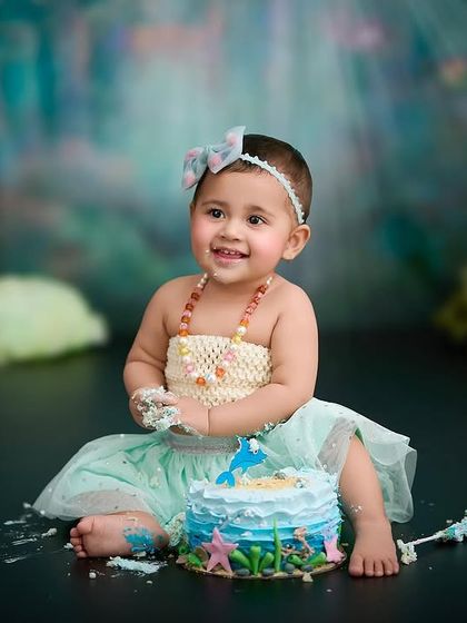 An under-the-sea themed cake smash. We used a custom cake and backdrop to create a magical mermaid celebration for her first birthday.