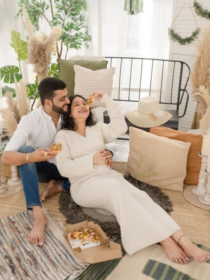Cravings and cuddles. This playful shot of a couple enjoying pizza during their maternity session adds a fun, personal, and candid touch to their gallery.