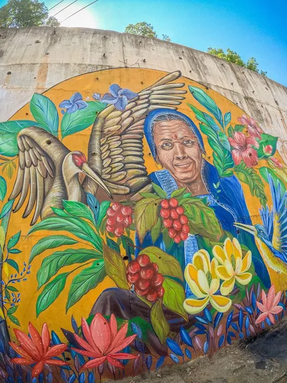 My canvas isn't always confined to a frame. This is 'My Kodavathi Beauty,' a large-scale mural I painted in Coorg. Taking art to the streets allows me to connect with communities and tell their stories on a grand scale. This work celebrates the local culture and the powerful women of the region.