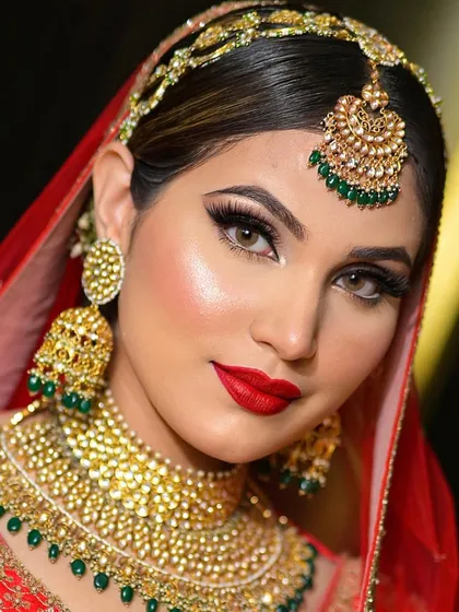 A quintessential bridal portrait. For this classic red bride, I created a bold yet elegant look with sharp, defined eyes and a timeless red lip. The focus was on creating a luminous, HD-ready complexion that lasts through all the ceremonies.