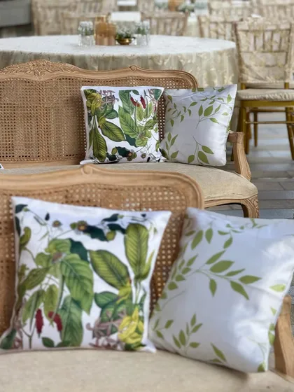 Classic details make all the difference. The botanical-print cushions on this vintage-style caned sofa add a touch of charm and sophistication to the lounge area.