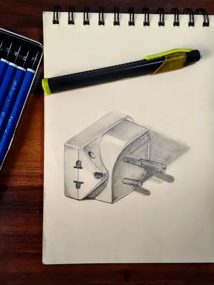 Another view of my travel adapter sketch, shown with the Staedtler pencils I used. Practicing still life helps sharpen my observational drawing skills.