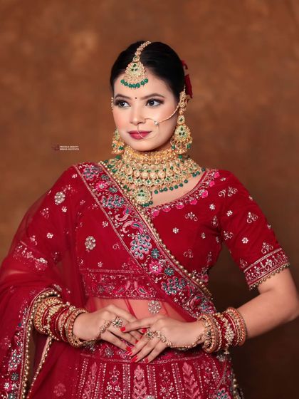 A confident pose from the bride. The traditional updo is essential for this look, keeping the focus on her radiant face and the magnificent details of her attire.