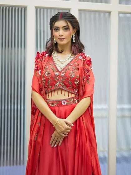 A full view of the client's Karva Chauth look, showing her elegant pose and the beautiful details of her outfit and makeup.